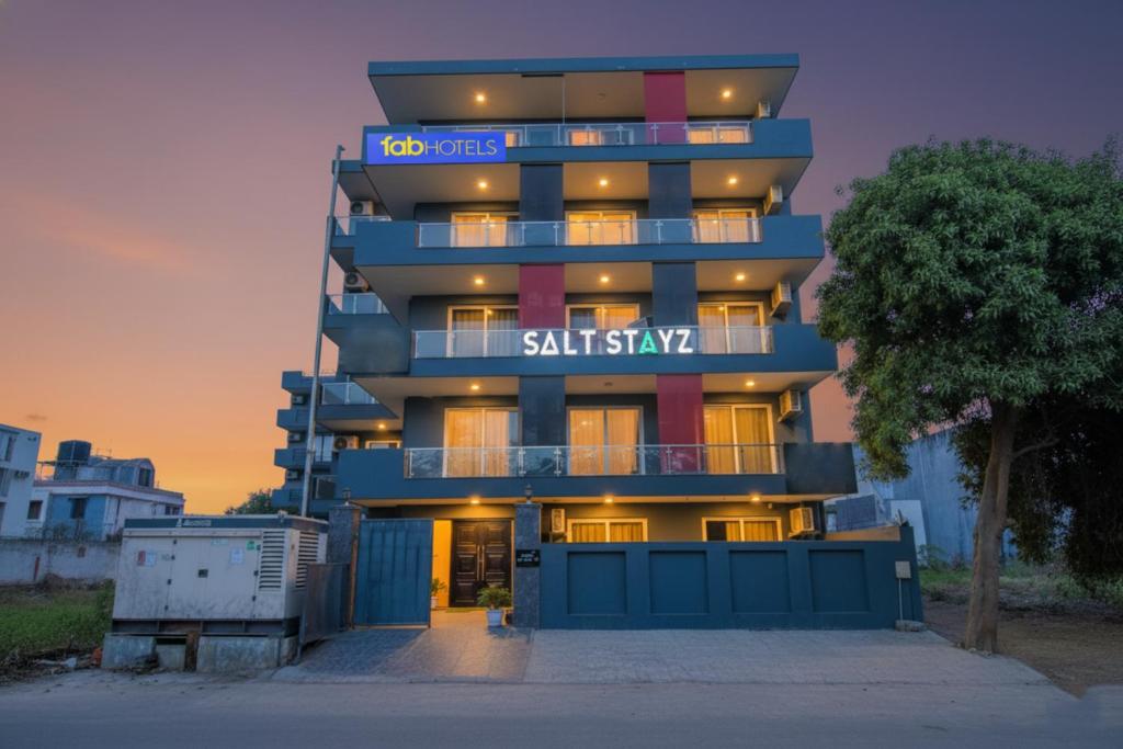 a tall building with a sign that reads sushi style at FabHotel Infinity Stays Near Medanta- The Medicity, Gurgaon in Gurgaon