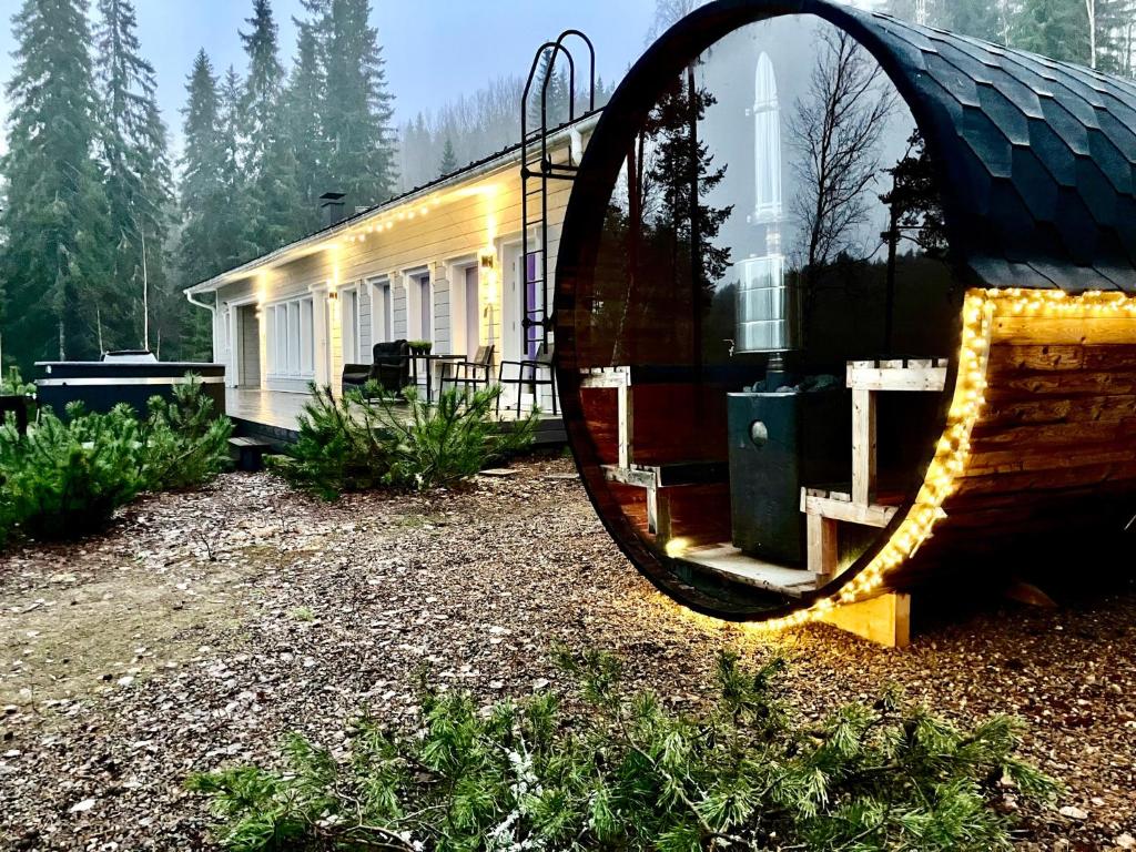 a mirror in front of a building with a church at Villa Renkaranta - Modern villa for 8-12 person, own beach, sauna & hot tub - surrounded by forests in Hämeenlinna