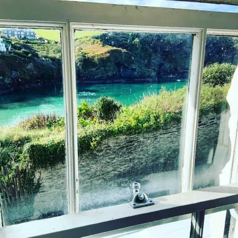 a window with a view of a river at Waves End - Port Isaac Cornwall in Port Isaac
