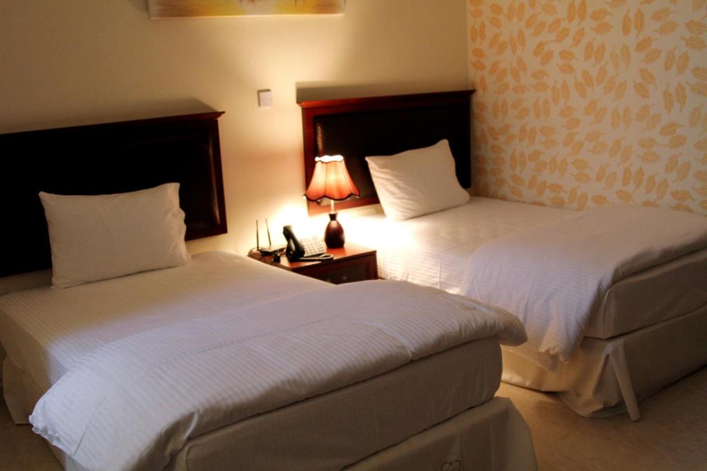 Postel nebo postele na pokoji v ubytování Dar Al Khaleej Hotel Apartments
