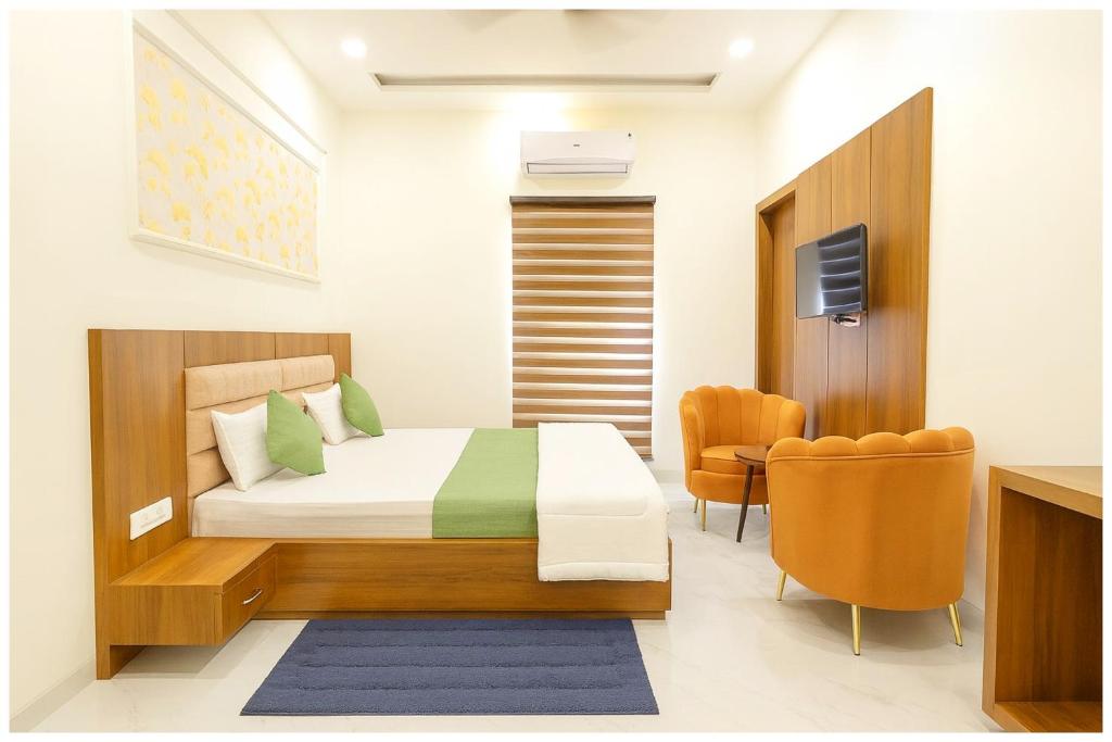 a hotel room with a bed and a chair at Mahavidya Road Hotel The Shrinath Premium Palace Near Masani Railway Station - Sri Krishna Janmabhoomi - Parking # Restaurant And Lift facilities - Fully Air conditioning Luxuary Room - Top Rated Hotel In Mathura in Mathura