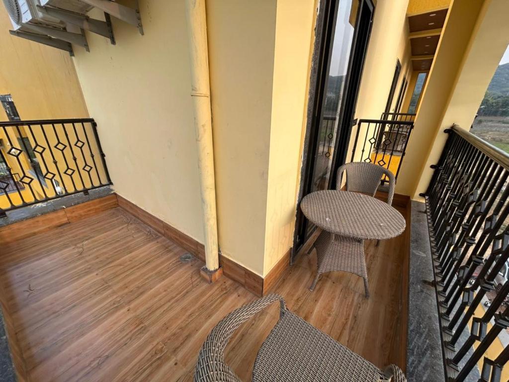 a balcony with two chairs and a table at Aijasvan Resort in Sawāi Mādhopur