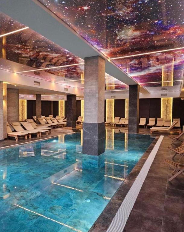 a pool in a building with a star ceiling at B8 Residence hill in Kopaonik