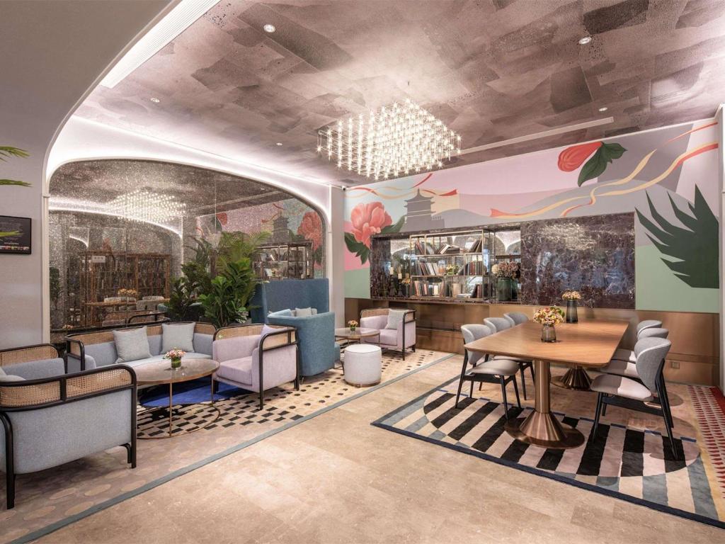 a restaurant with chairs and tables in a room at Mercure Xi'an High-tech Zone Center in Xi'an