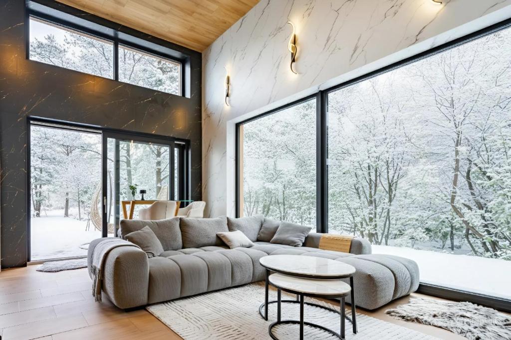 a living room with a couch and a table at Green Field Villa in Kuressaare