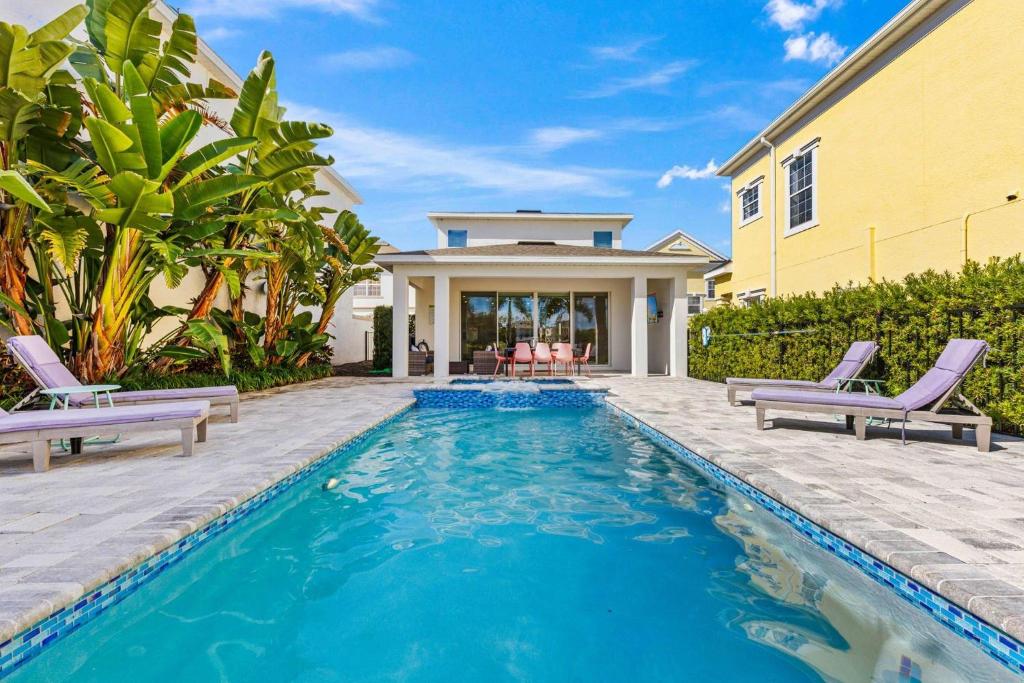 a swimming pool in front of a house at LC517T The Chic Abode at Liberty Bluff in Kissimmee
