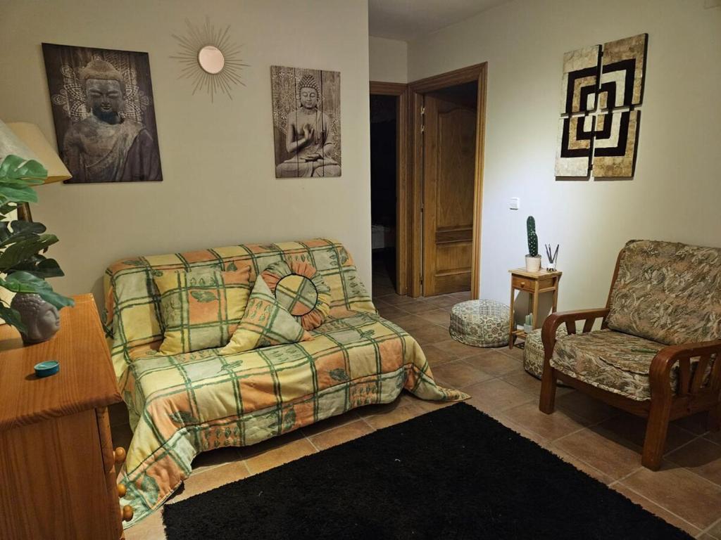 un soggiorno con un divano e una sedia di Encanto Rural ad Arnedillo