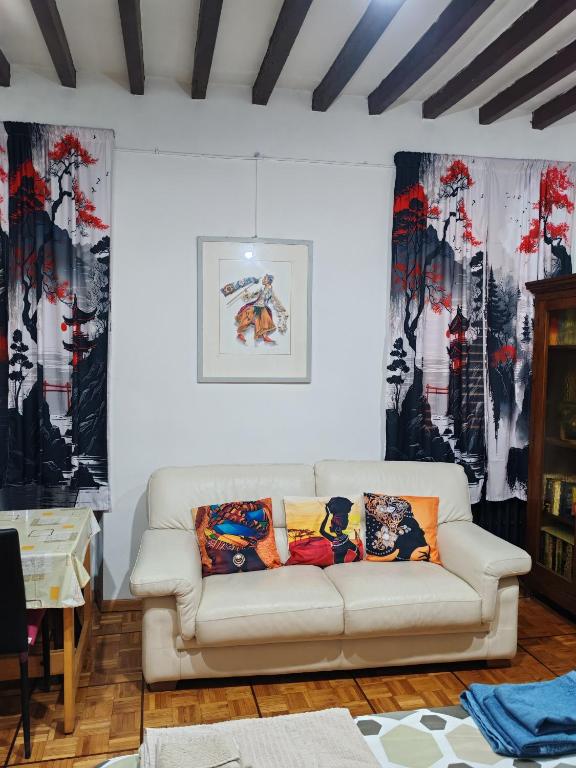 a living room with a white couch and curtains at Casa Chicco Parma in Parma