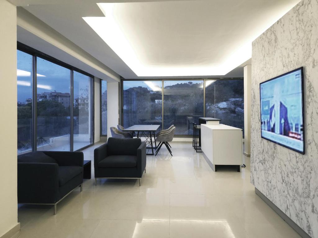 a living room with a large wall of windows at Tabarja Heights in ‘Ayn aş Şughayrah
