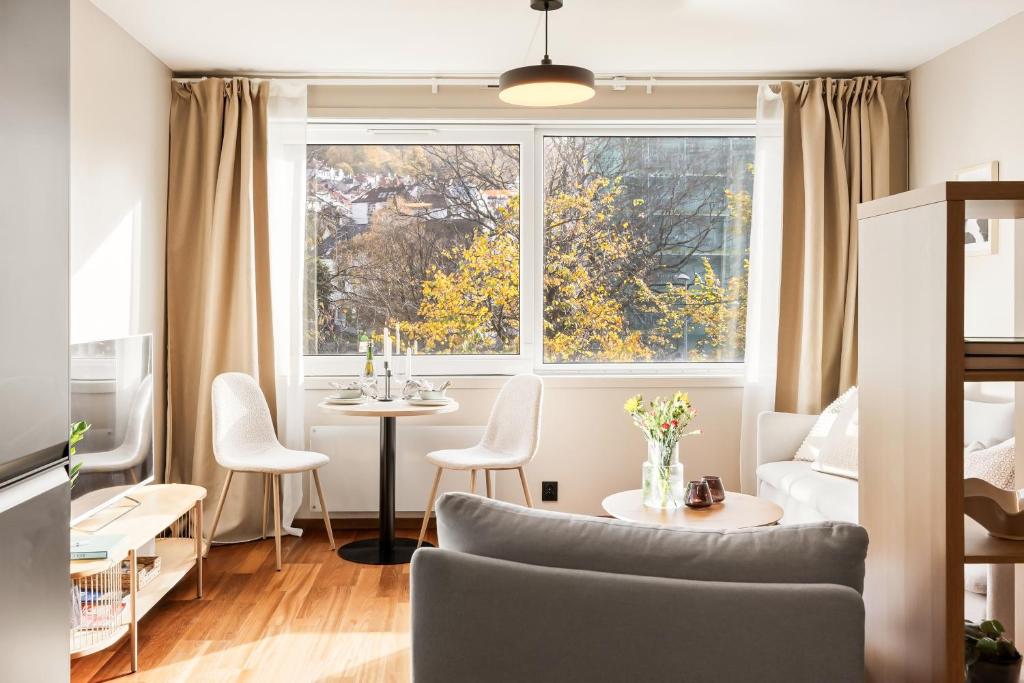 a living room with a couch and a table at Modern Suites, Excellent Location in the heart of Bergen in Bergen