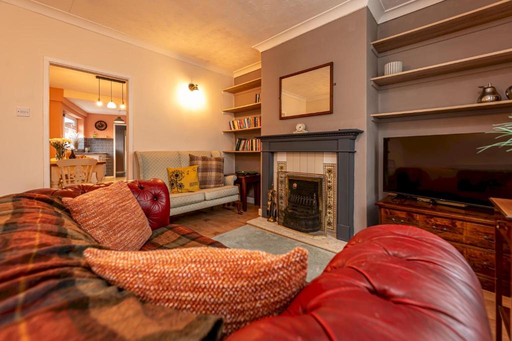 a living room with a couch and a fireplace at Charming Cottage in the Heart of Newport - Pass the Keys in Newport
