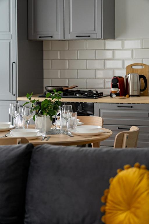a kitchen with a table with wine glasses on it at Urban Modern Apartment - AFI Arad in Arad