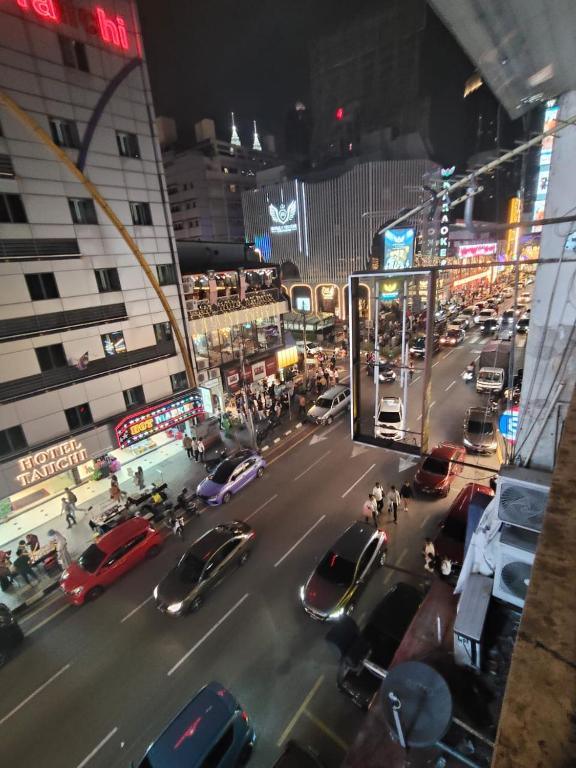 a busy city street at night with cars and buildings at NOVA HOTEL Bukit Bintang in Kuala Lumpur