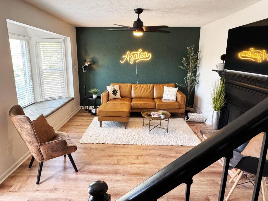 a living room with a couch and a fireplace at Azalea: 2 primary bedrooms w/ bathrooms in Augusta
