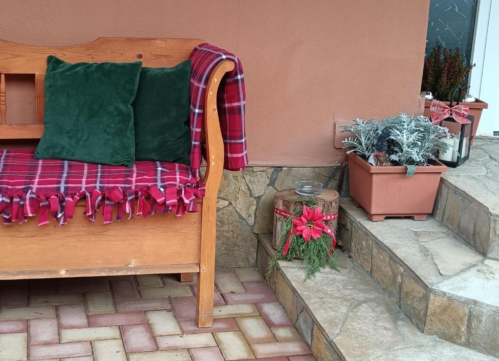 a bed on a patio with christmas decorations and plants at Hársfa apartman in Makó