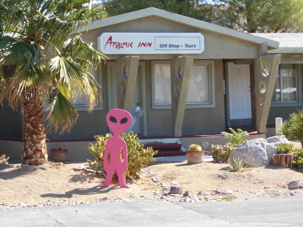 a pink octopus statue in front of a house at Atomic Inn Beatty Near Death Valley in Beatty