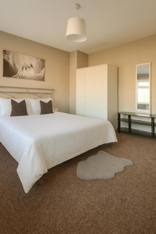 a bedroom with a large white bed and a desk at City Stays Norwich NR3 in NWI