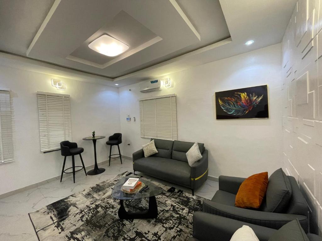 a living room with a couch and a table at Spacious one bed self compound in Iju Junction