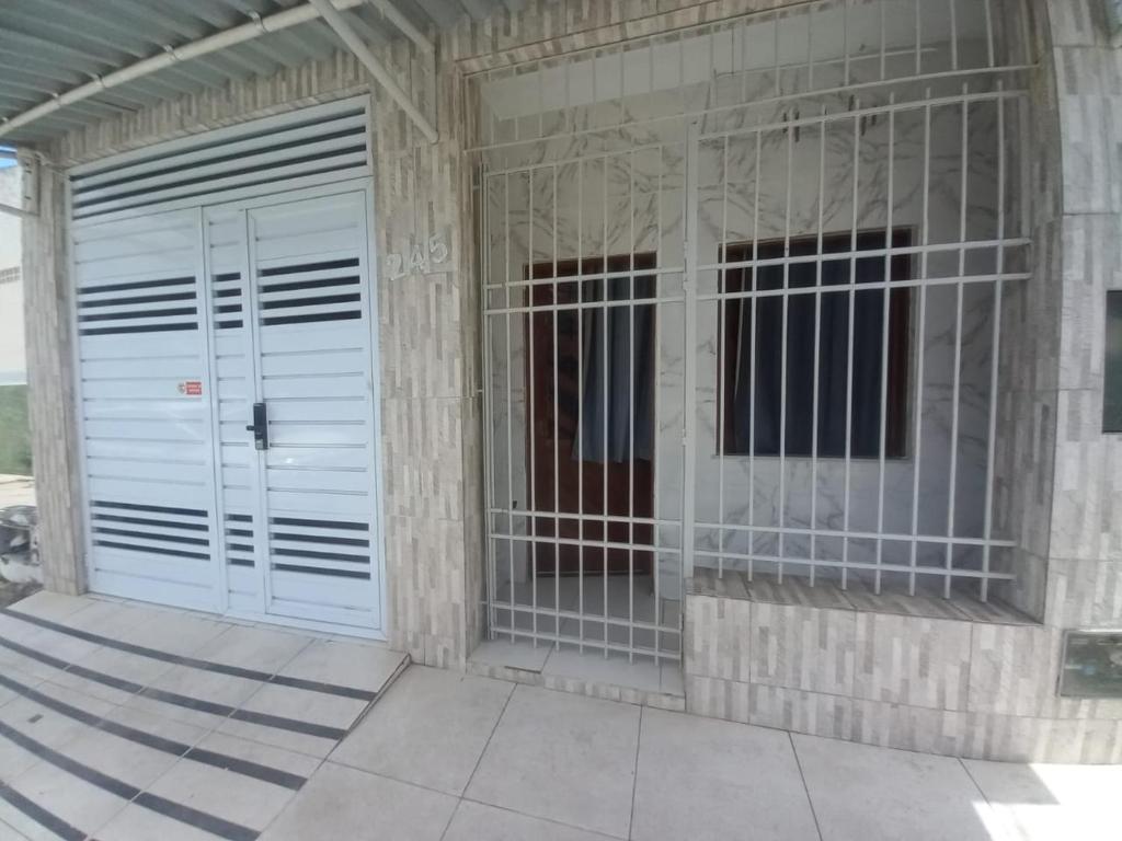 a building with two white doors on the side at Aracaju Suite - Seu Conforto no Coração da Capital in Aracaju