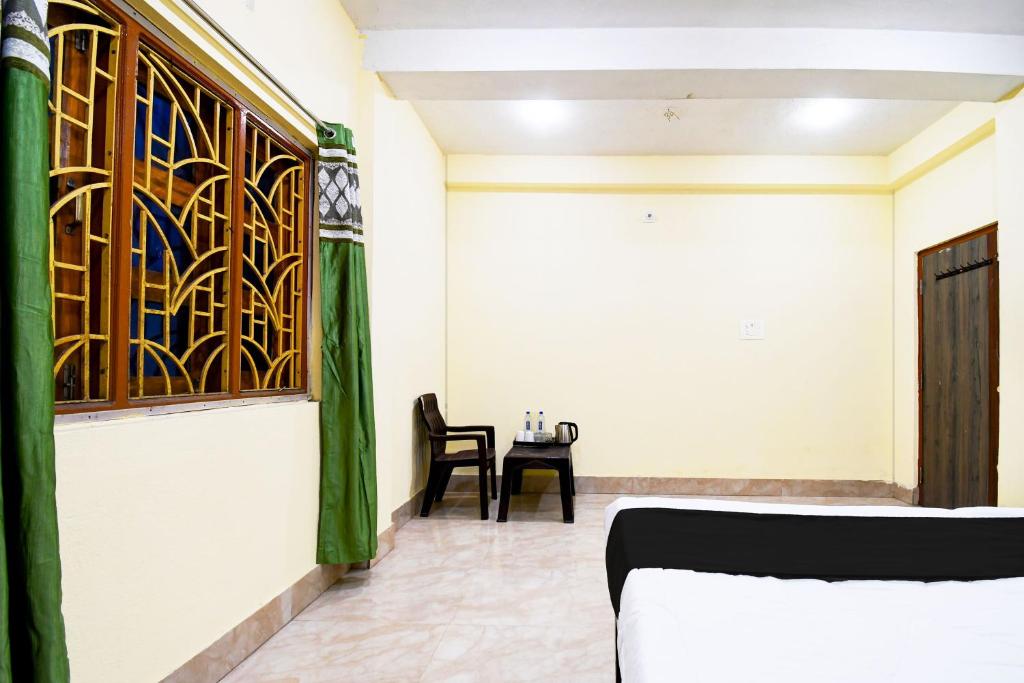 a room with a bed and a table with a chair at Hotel O HIGHWAY STAY IN in Bandha Chhada