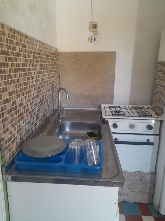a kitchen with a sink and a stove at Paloma in Atlántida