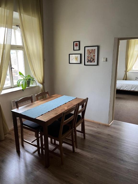 a dining room table and chairs in a room at Apartmán Ekonomy in Spělkov
