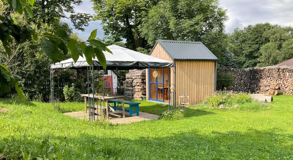 a small building with a tent in a field at Apartmán Ekonomy 