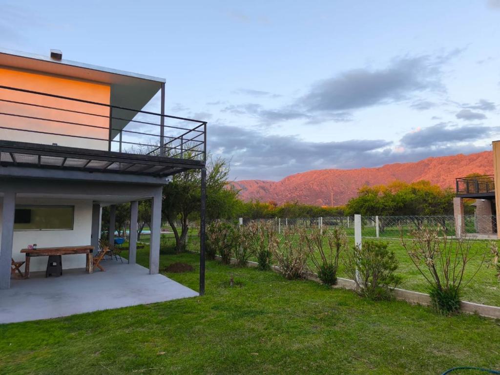 a house with a picnic table in a yard at Atardeceres del dique in Cortaderas