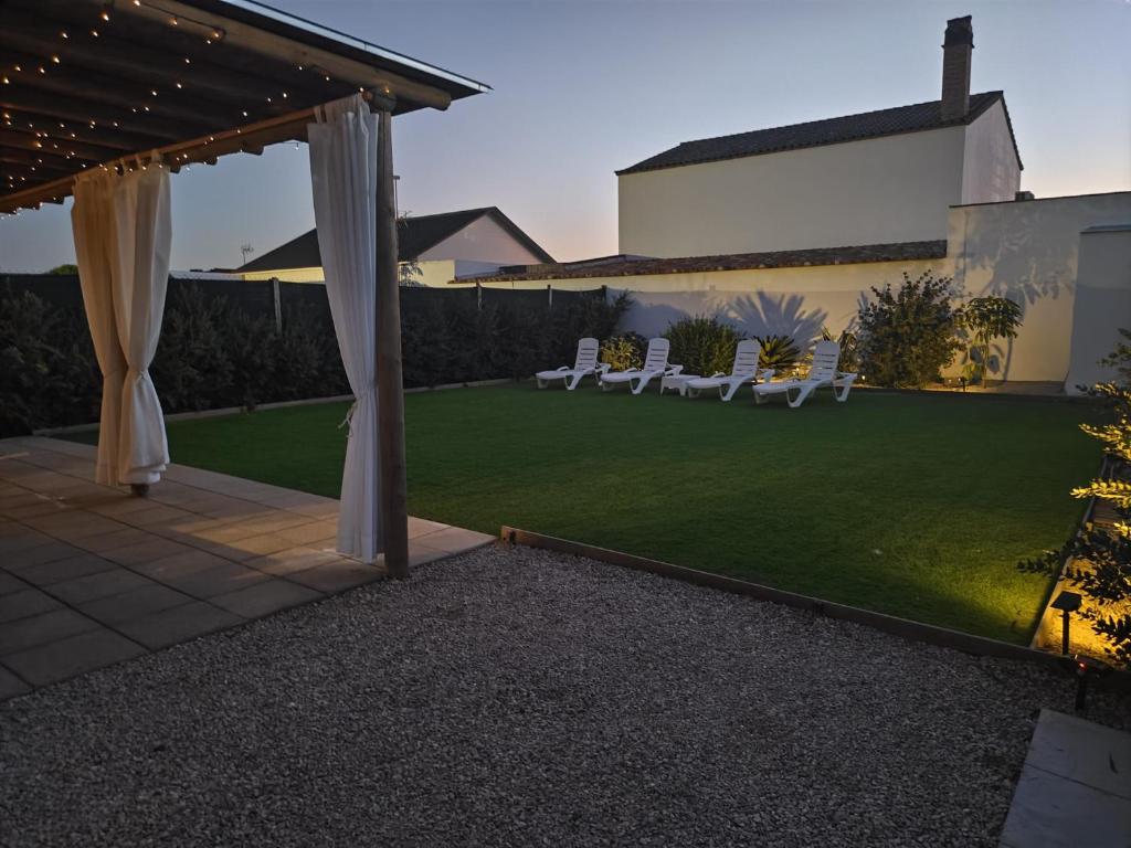 a backyard with a lawn and a gazebo at Casa Olas y Arena el Palmar in El Palmar