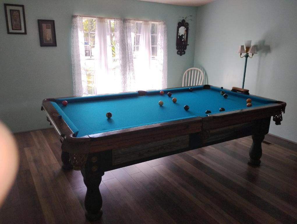 a pool table in the middle of a room at Serenity Now Sunset Beach in Sunset Beach