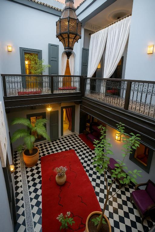 arium of a building with a red carpet and plants at BKAN RIAD MARRAKECH in Marrakesh