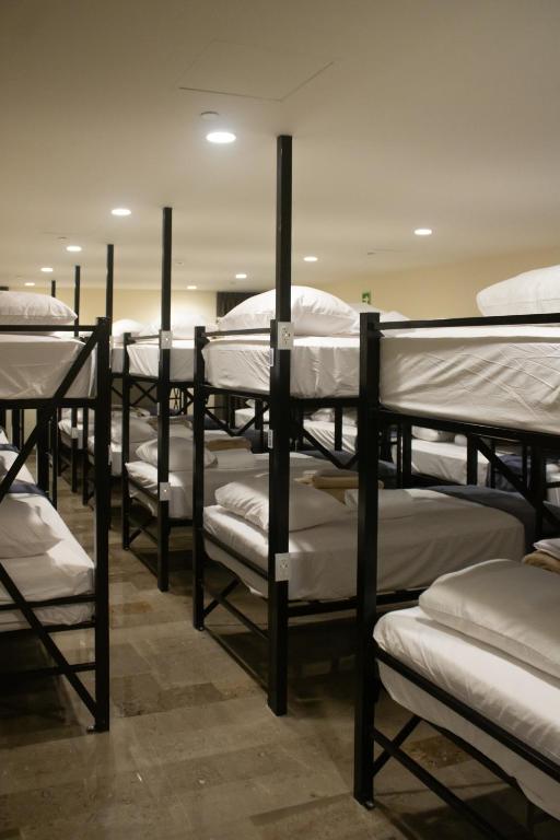 a row of bunk beds in a room at Travohostal Monterrey Historico in Monterrey