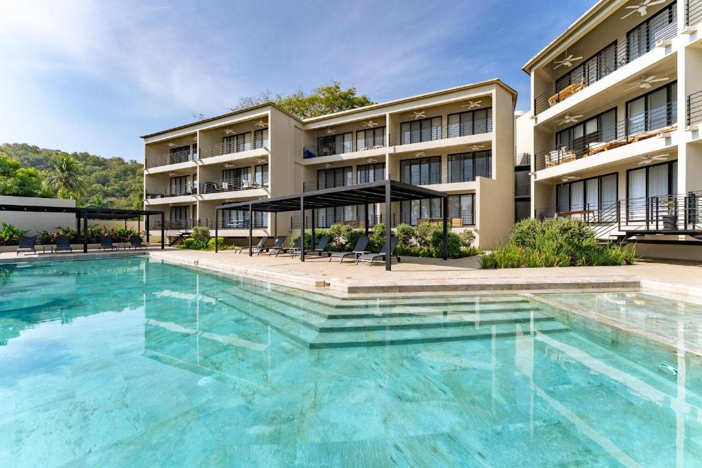 a large swimming pool in front of a building at 3062 - Solana C203 in Cedro
