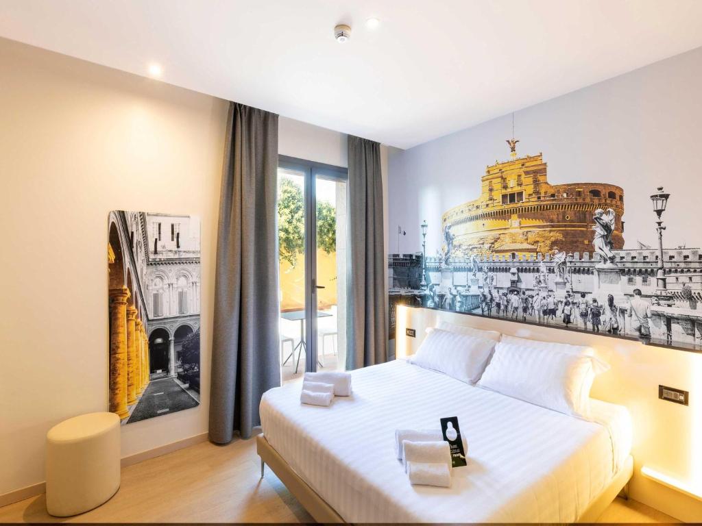 a bedroom with a large bed with a picture on the wall at B&B Hotel Roma Tuscolana San Giovanni in Rome