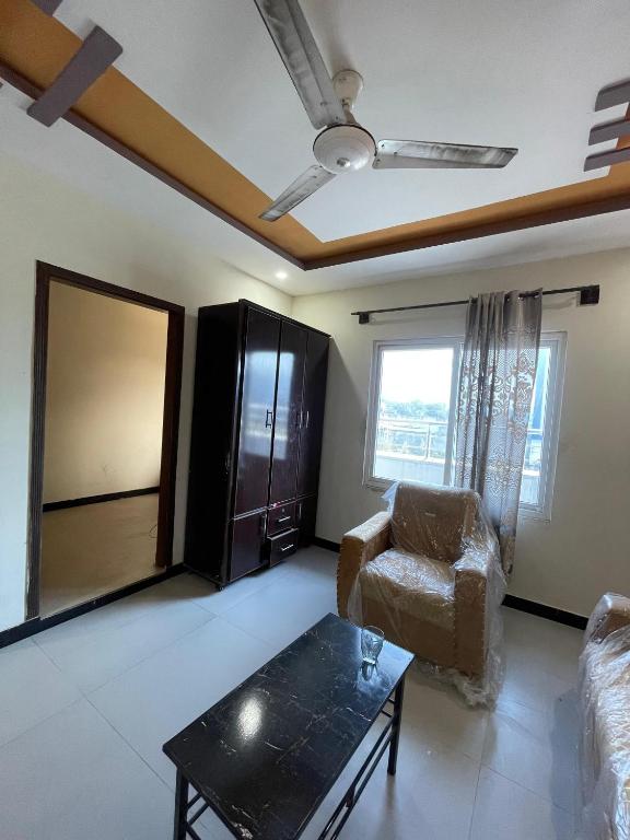 a living room with a couch and a table at Sherazi Arcade in Islamabad