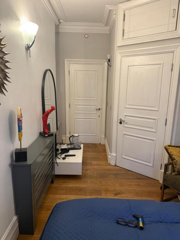 a room with a bedroom with a bed and a mirror at PICCADILLY Private room and bathroom in Manchester