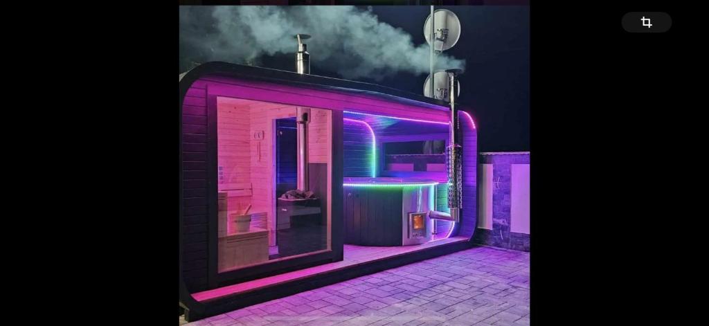 a building with purple and pink lights on it at Vila Liana in Stana