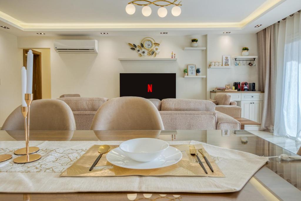 a living room with a table with a plate on it at Luxurious 3Bd Hotel Apt in compound Sheikh Zayed with Pool and Gym access in Sheikh Zayed