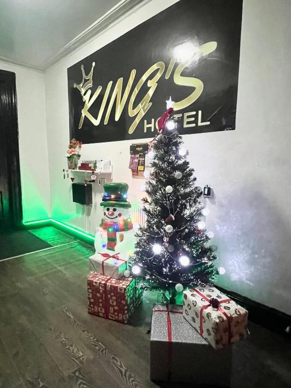 a christmas tree with presents in a room at King Street Hotel in Blackburn