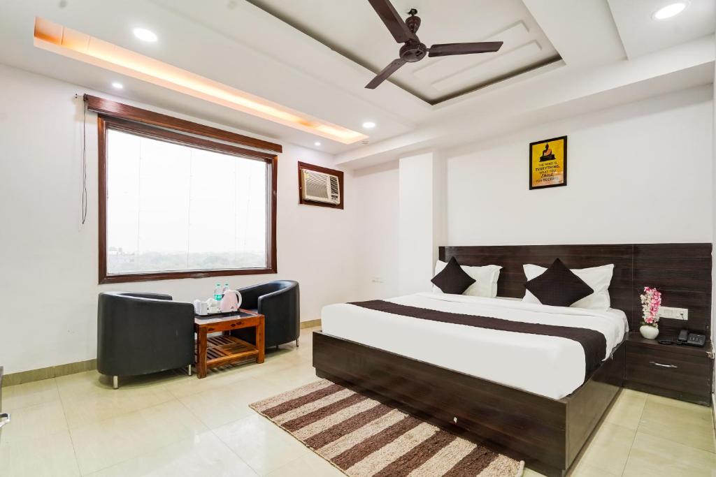 a bedroom with a large bed and a window at Yashobhoomi Grand in Jāmb