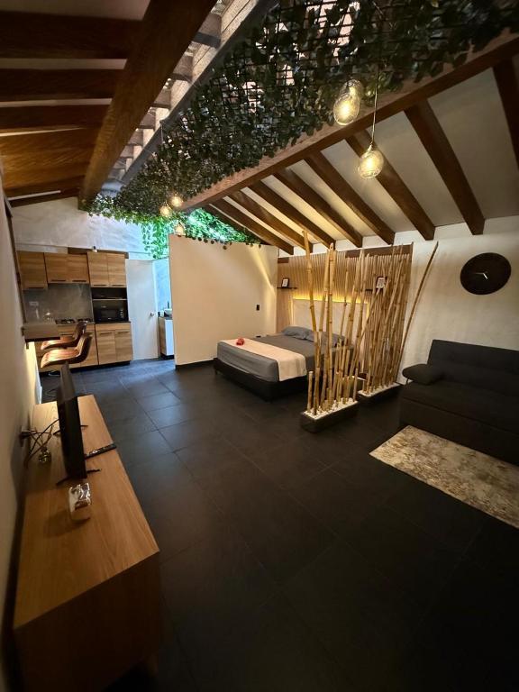 a living room with a bed and a couch at Apartamento tipo loft in Guarne
