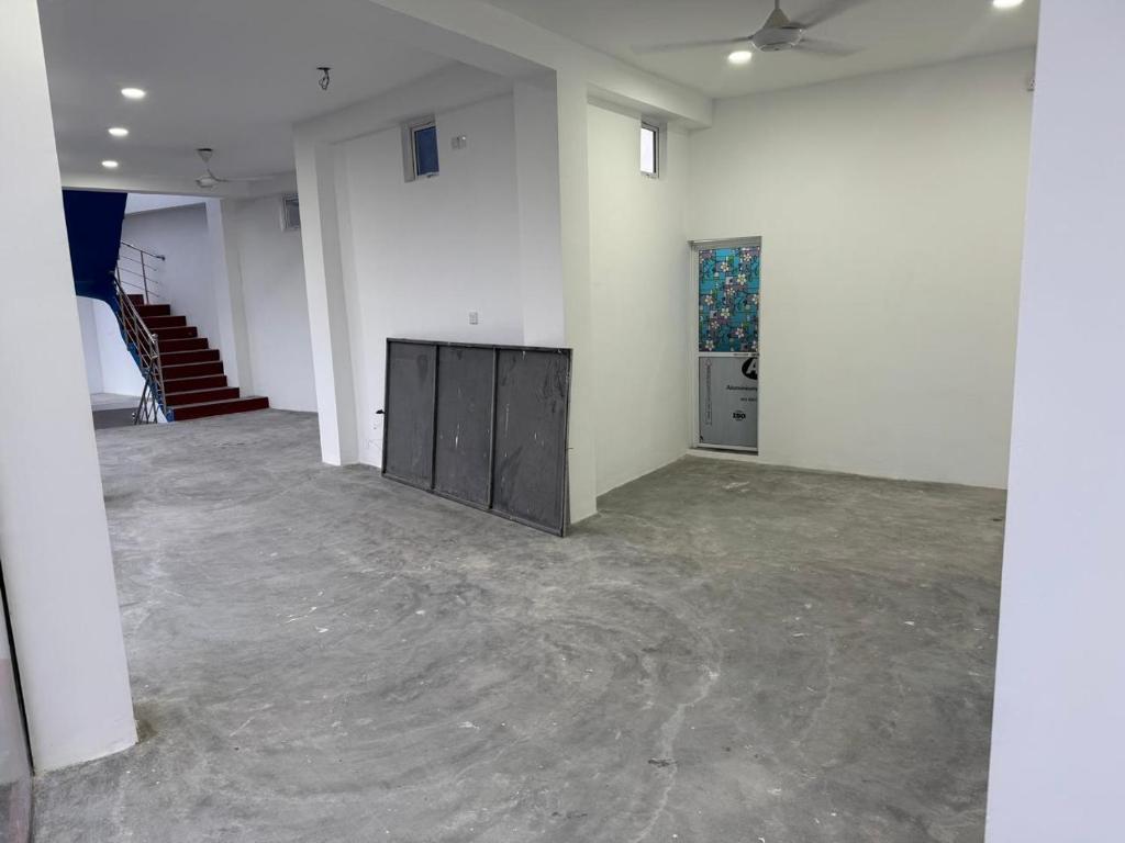 an empty room with white walls and a staircase at Mark International in Colombo