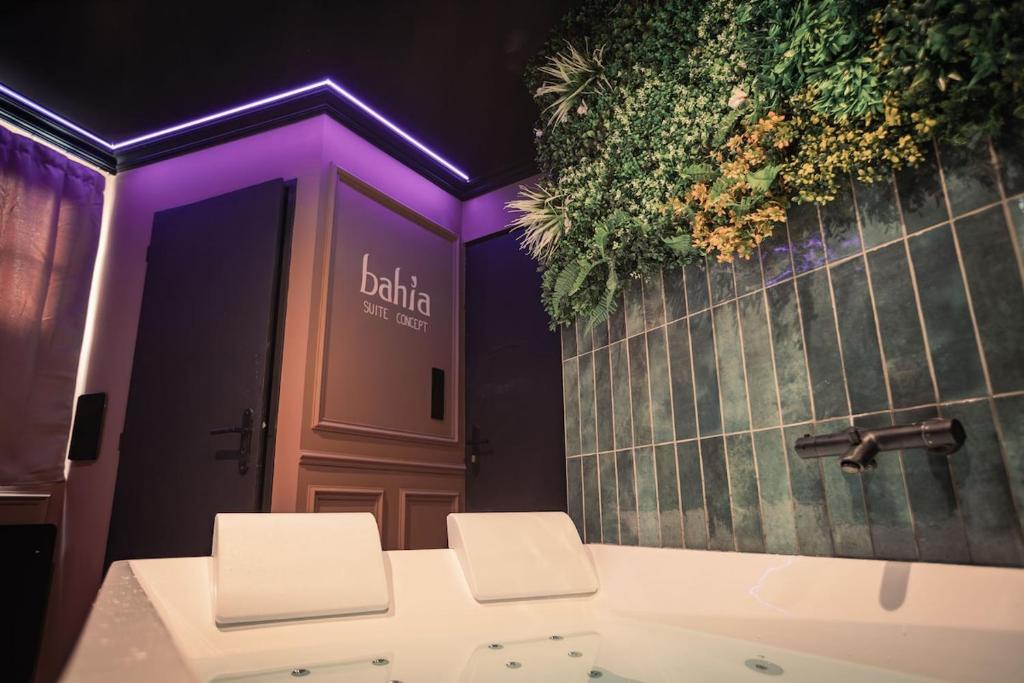 a bathroom with two white toilets and a sink at BAHIA -Suite romantique & SPA Privé in La Roche-sur-Yon