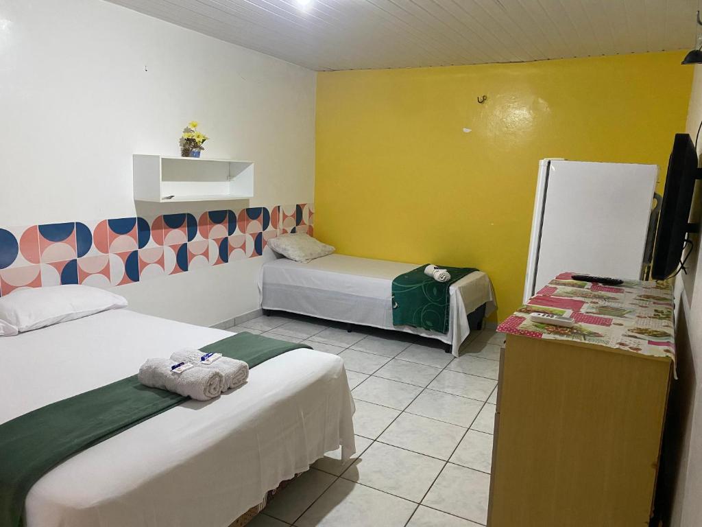 Ένα ή περισσότερα κρεβάτια σε δωμάτιο στο Bru&Mar Pousada