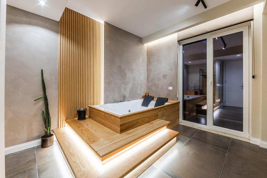 a bathtub in a room with a large window at Zoe's Villa by PS in Durrës