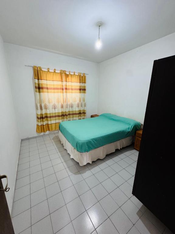 a small bedroom with a bed and a window at Casa en Nono traslasierra in Nono
