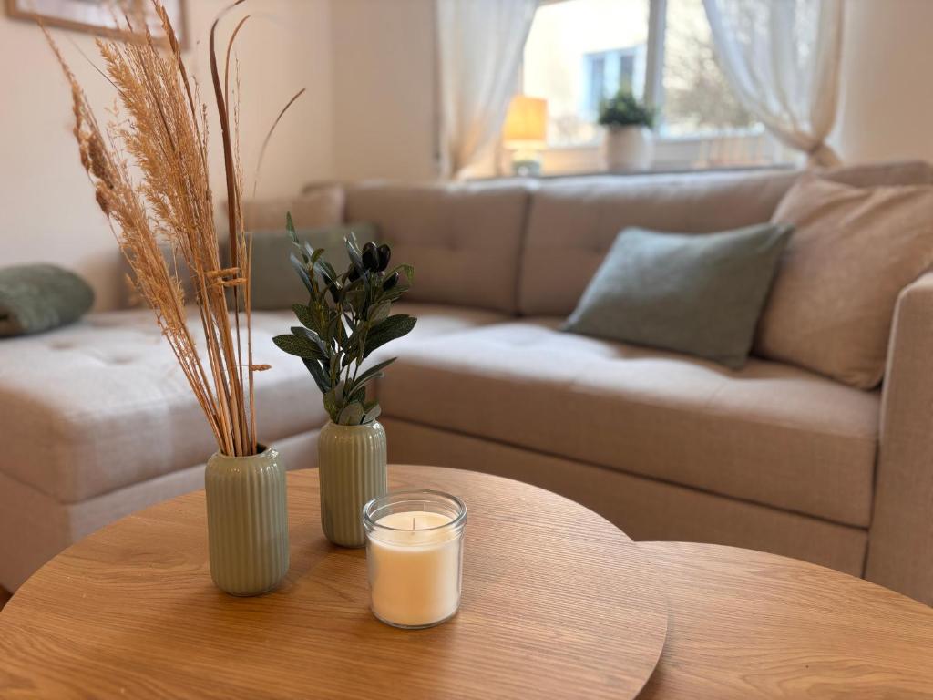 a living room with a table with a glass of milk at Fewo Eirich in Günzburg