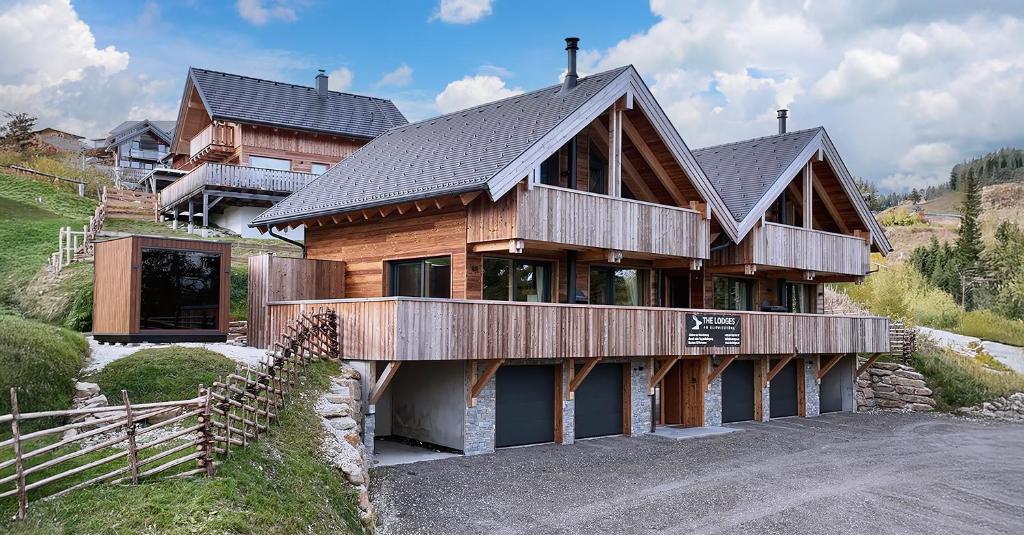 a large wooden house on top of a hill at The Lodges am Klippitztörl - Chalet in Klippitztorl