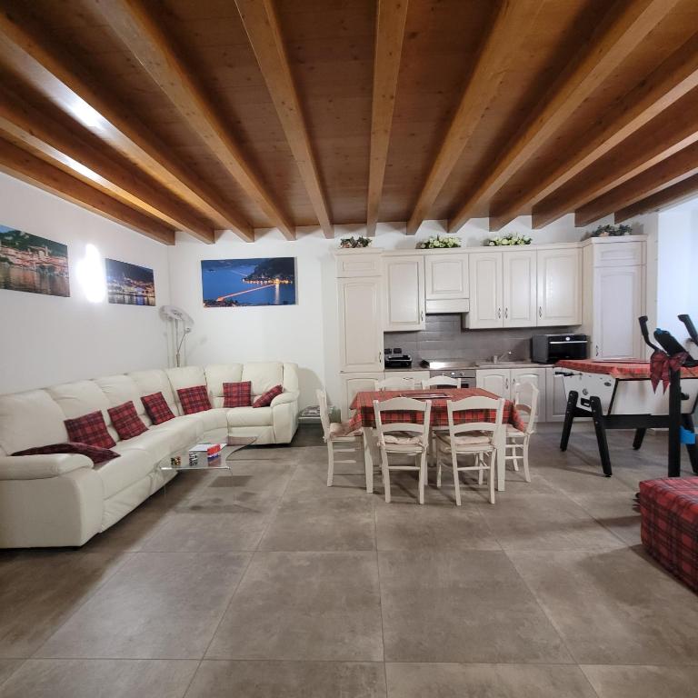 a living room with white furniture and a table at Eva Lake Endine Hospitality in Endine Gaiano