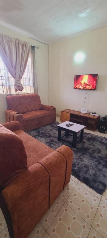 a living room with a couch and a coffee table at Avian suits in Kisumu